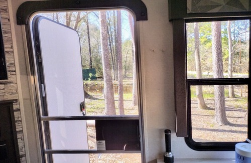 Plantersville Casa | 1BR 32' RV by Pond, Clean, Safe and Affordable with Playground and Pool.