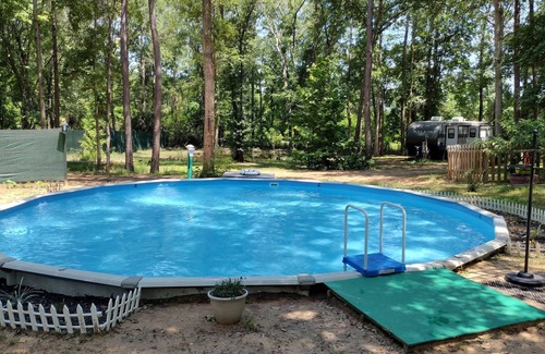 Plantersville Casa | 1BR 32' RV by Pond, Clean, Safe and Affordable with Playground and Pool.