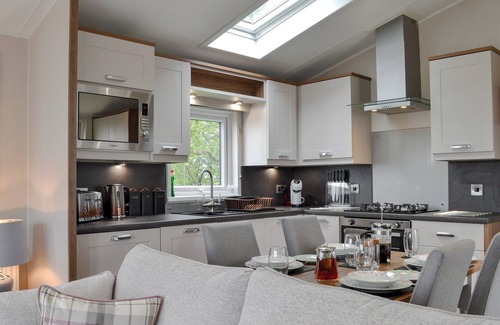 Penrith Cabaña | Detached luxury lodge with open plan living space, sleeps four, decked area and hot tub.