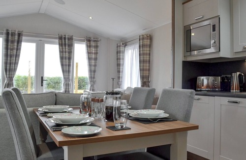 Penrith Cabaña | Detached luxury lodge with open plan living space, sleeps four, decked area and hot tub.