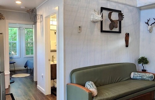 Mill Spring Cabina | 2-story treehouse with a cargo net connecting the upstairs lofts, a large balcony with a slide to the ground level, sleeps 10.