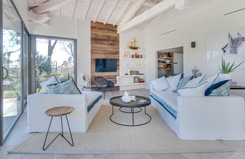 Magalas Apartamento | A large table with chairs and a garden furniture with sunbeds