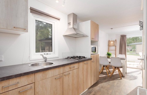 Zuna Cabina | A spacious bungalow with a nice veranda and a view of the playground