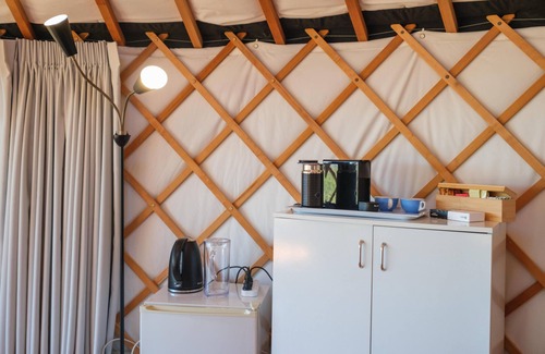 Palm Beach Cabina | Awaawa Yurts - Rangi Yurt - Awaawa Yurts offer a luxury glamping experience on Waiheke Island. Stunning views, luxury queen sized bed, private bathroom with tea and coffee making facilities.
