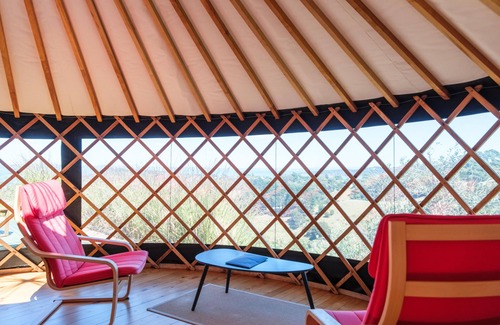 Palm Beach Cabina | Awaawa Yurts - Rangi Yurt - Awaawa Yurts offer a luxury glamping experience on Waiheke Island. Stunning views, luxury queen sized bed, private bathroom with tea and coffee making facilities.
