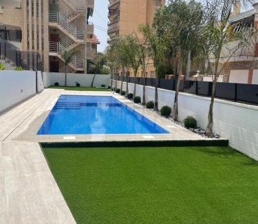 Santiago de la Ribera Apartamento | Beach bungalow with swiming pool and long terrace