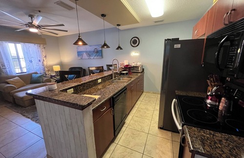 National Gardens Condominio | Cozy 1-bedroom condo with 75 inch TV, Granite & stainless kitchen, Pool, W&Dryer