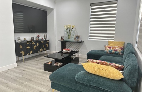 San Fernando Casa | Bedroom and bathroom in a quiet townhouse.