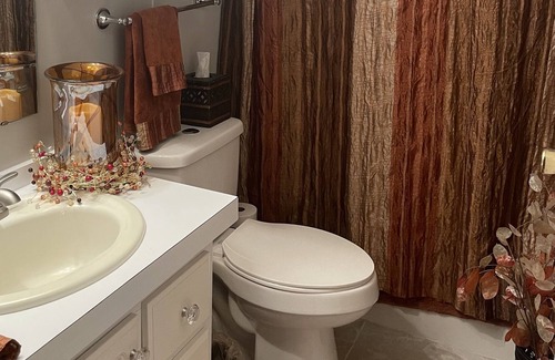 Charlotte Park Casa | Bedroom with a queen size bed and bath. Shared kitchen and lanai.