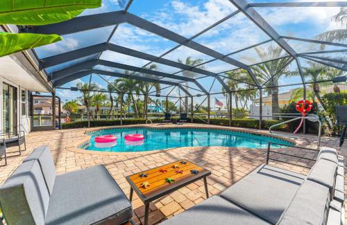 Cocoa Isles Villa | Casa De Olas - Waterfront Luxe Home - Heated Pool - Game Room - Boat Lift - Minutes to Beach