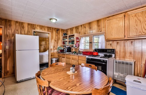 Three Lakes Casa | Charming, dog-friendly, lakefront cottage with boat dock, grill, & firepit