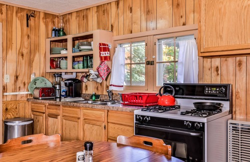 Three Lakes Casa | Charming, dog-friendly, lakefront cottage with boat dock, grill, & firepit