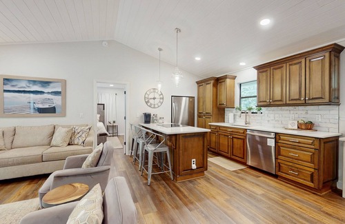 Sylva Casa | Riverfront getaway with a deck, yard, private hot tub, fireplace, and grill