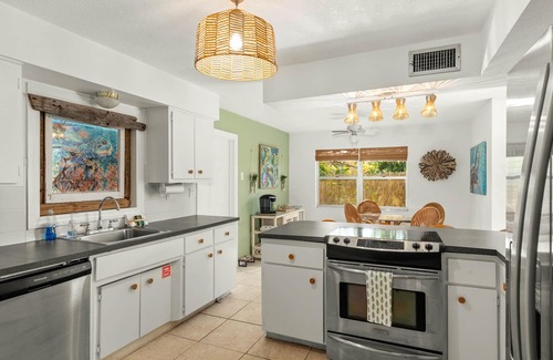 River Isles Casa | Coconut cove - peaceful garden retreat with HEATED pool on canal near the beach!