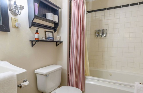 Stowe Cama Y Desayuno | Comfortable room with queen bed and daybed with windows on 3 sides, a stunning view of Mount Mansfield and a parlor stove with full service breakfast included