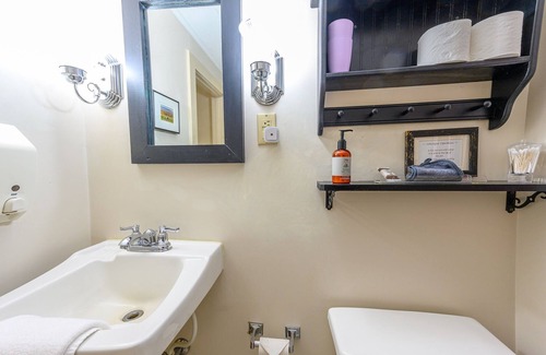 Stowe Cama Y Desayuno | Comfortable room with queen bed and daybed with windows on 3 sides, a stunning view of Mount Mansfield and a parlor stove with full service breakfast included