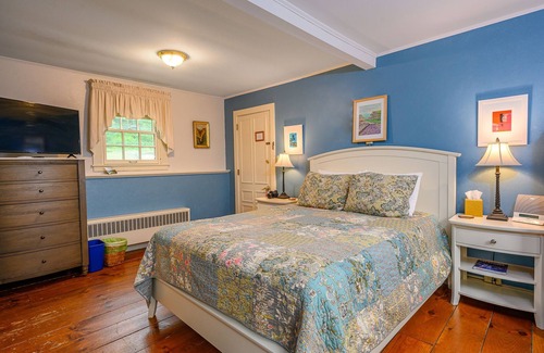 Stowe Cama Y Desayuno | Comfortable room with queen bed, a stunning view of Mount Mansfield, sitting area and a parlor stove with full service breakfast included