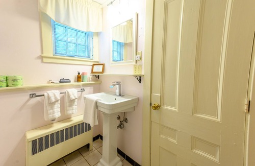 Stowe Cama Y Desayuno | Comfortable room with queen bed, a stunning view of Mount Mansfield, sitting area and a parlor stove with full service breakfast included