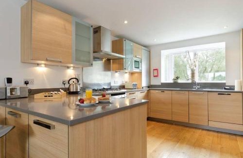 Cirencester Casa | Cotswolds Lake side home with luxury spa Swallows Nest,Lower Mill Estate, Lakeside home and spa with a Harry Potter cupboard under the stairs