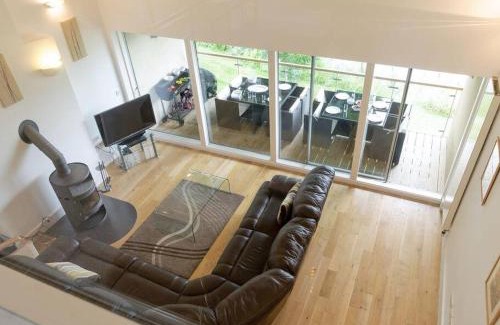 Cirencester Casa | Cotswolds Lake side home with luxury spa Swallows Nest,Lower Mill Estate, Lakeside home and spa with a Harry Potter cupboard under the stairs