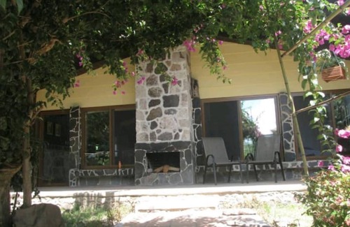 Panajachel Cabaña | Cozy country cottage with wooden ceilings and stone walls within nature reserve.