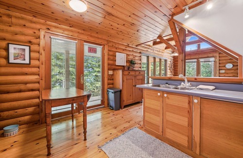 Lion's Head Cabina | Disconnect from it all at Stonewood, a cozy log chalet nestled in cedar forest on Georgian Bay. Enjoy a private shoreline, wraparound deck, wood stove, and access to kayaks, and trails. Peace, comfort, and adventure await in Cape Chin South.