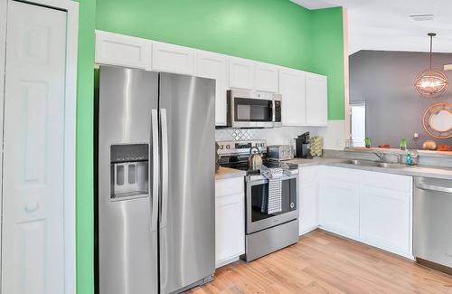 Wellington Casa | Dog-friendly home with pool, game room, AC, & washer/dryer