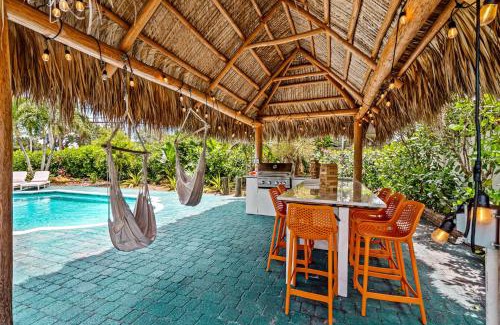 Garden Isles Casa | Eccentric home with pool tiki hut & outdoor kitchen