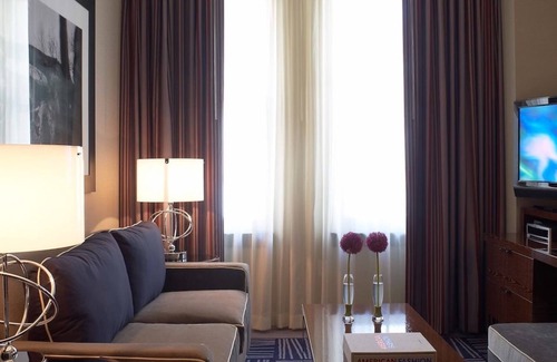 Downtown Dallas Hotel | Elegant Suite with King Bed, Lounge Area, and Designer Details