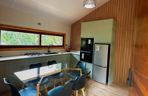 Pucon Cabaña | Enarbol Lodge, private hot tube on terrace. High-rise house among trees