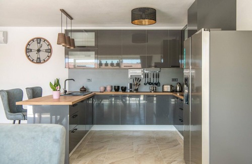 Kozljani Casa | Enjoy a relaxing time in this modern vacation home with pool.