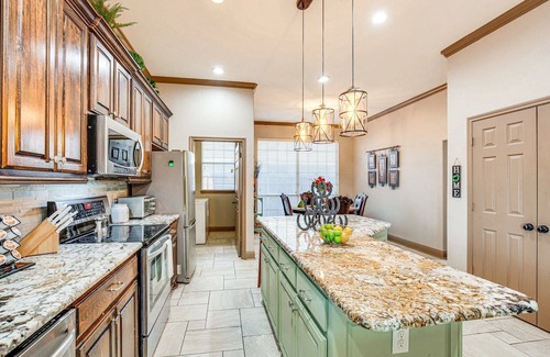 Rowlett Casa | Enjoy the peace and quiet back patio with Lagoon pool.