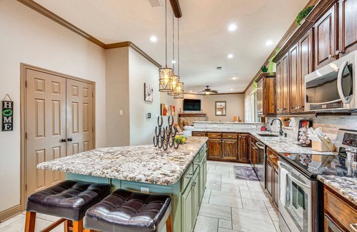 Rowlett Casa | Enjoy the peace and quiet back patio with Lagoon pool.