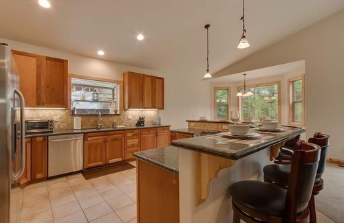 Tahoe Island Casa | Enjoy the tree-lined yard, spacious deck, and hot tub!