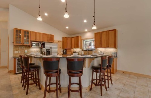 Tahoe Island Casa | Enjoy the tree-lined yard, spacious deck, and hot tub!