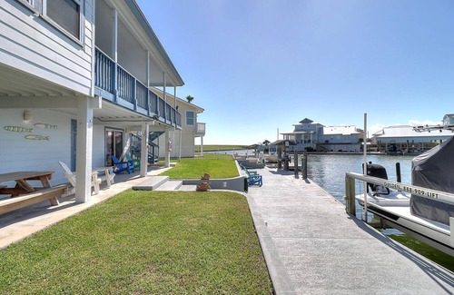 City-by-the Sea Casa | Estes Oasis! Canal front home with private lighted dock! Views! Foosball game