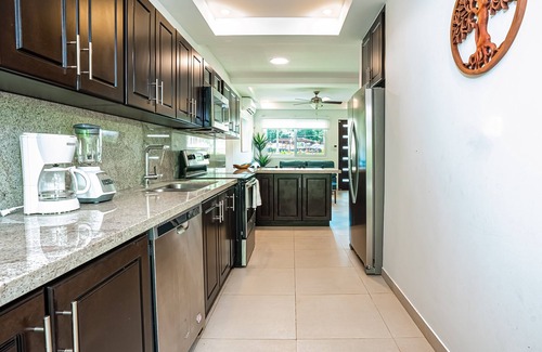 Villarreal Condominio | Gated resort condo with on-site pool, outdoor areas, private patio, & W/D