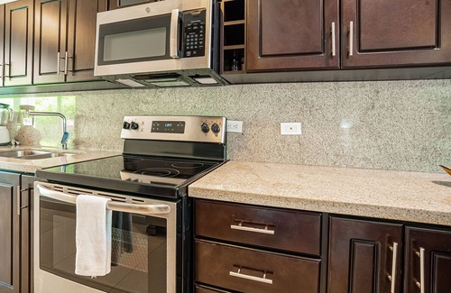 Villarreal Condominio | Gated resort condo with on-site pool, outdoor areas, private patio, & W/D