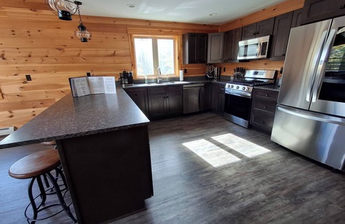 Carrabassett Valley Cabina | Gorgeous dog-friendly cabin with great view, deck, hot tub, & gas fireplace