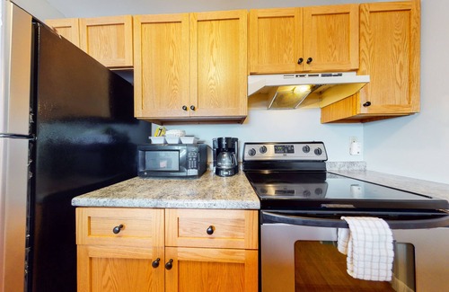 Gilford Condominio | Inviting condo in quiet locale with partial lake views, balcony & grilling area