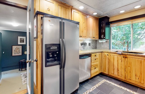 Lake Grove Casa | Inviting home with enclosed yard, firepit, hot tub, hammock, washer/dryer