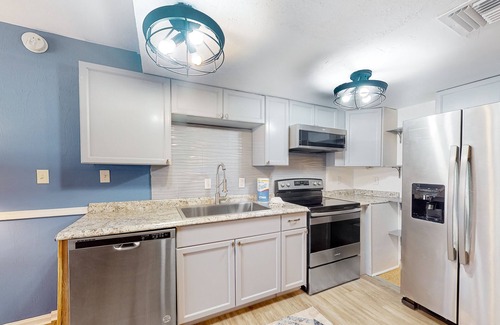 East End Casa | Inviting townhouse with on-site pool, updated interior, & W/D
