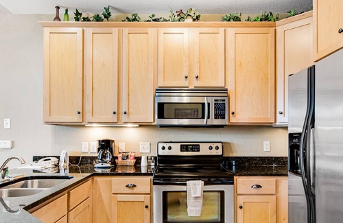 Three Lakes Condominio | Lake-view condo with pool and hot tub access, jetted tub, firepit, and a balcony