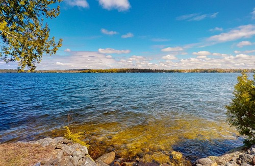 Otis Casa | Lakefront home with dock, kayak, firepit, screened porch, fireplace, & W/D