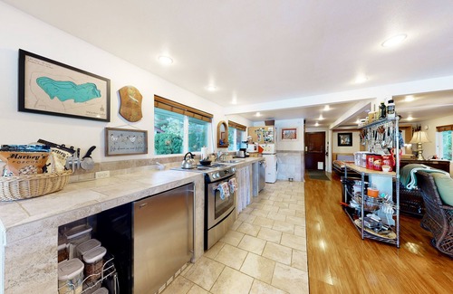 Mason County Casa | Lakefront studio-like home with beach access, lake views, wood stove, & firepit