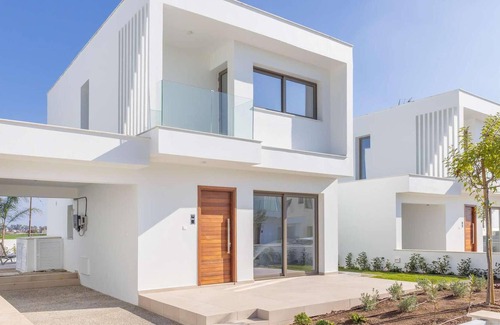 Softades Casa | Larnaca Blue 16 is a contemporary villa on a gated complex.