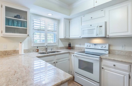 Moorings Condominio | Less than 2 miles to the beach! West of 41 condo with pool and hot tub!