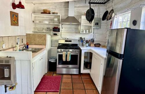 San Cristobal Casa | Log Casita Overlooking Pond and Waterfall near Taos, New Mexico