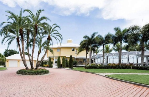 Palm City Casa | Lush Waterfront Pool Home and Pool house with Pickleball court and Boat dock