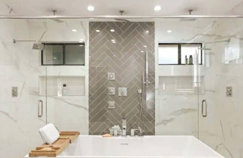 Modesto Casa | Lux Home wall-to-wall shower with nine heads ensuring a luxurious experience.